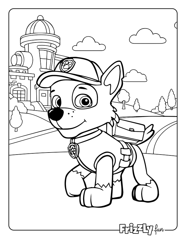 Chase from Paw Patrol looks ahead bravely with buildings behind him.